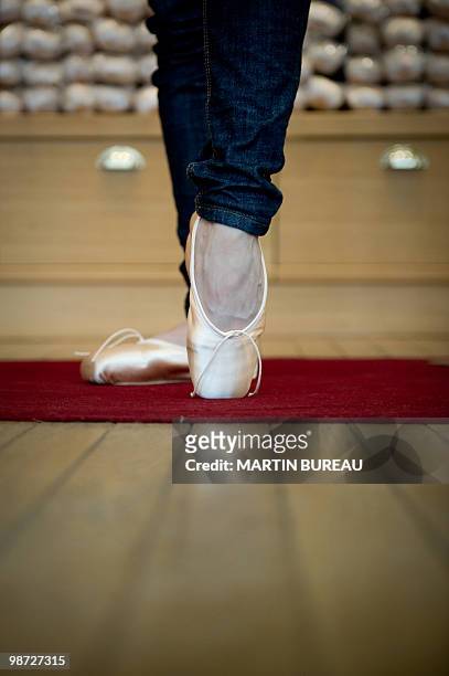 French ballet dancer Daphne Gestin tries a pair of ballet shoes at Repetto store on March 19, 2010 in Paris. Created in 1947 by Rose Repetto, at the...