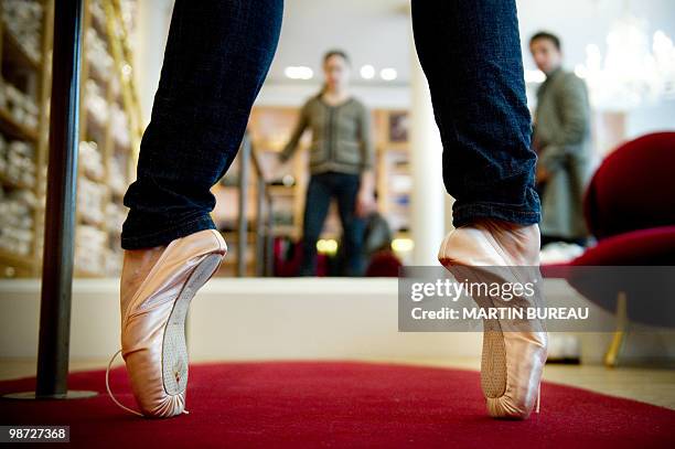 French ballet dancer Daphne Gestin tries a pair of ballet shoes at Repetto store on March 19, 2010 in Paris. Created in 1947 by Rose Repetto, at the...