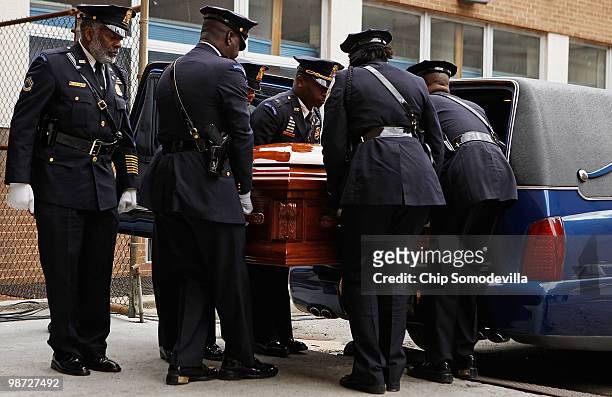 Members of the District of Columbia Metropolitan Police Honor Guard carry Dorothy Height's casket into the back of Howard University's Burr...