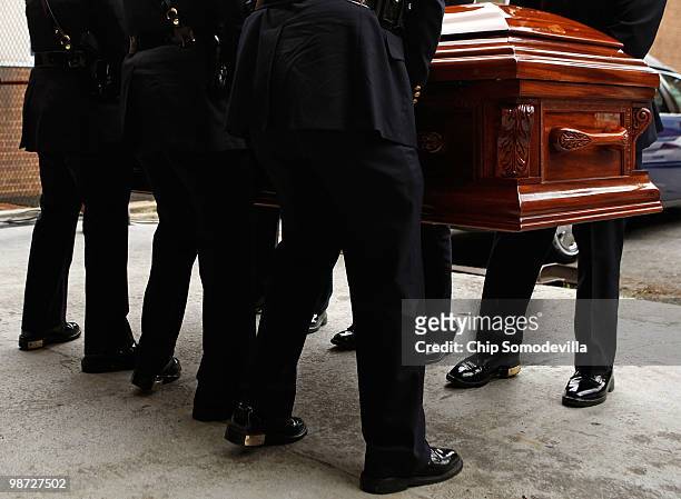 Members of the District of Columbia Metropolitan Police Honor Guard carry Dorothy Height's casket into the back of Howard University's Burr...
