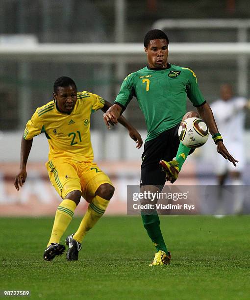 Ryan Johnson of Jamaica controls the ball as Siyabonga Sangweni of South Africa looks on during the international friendly match between South Africa...