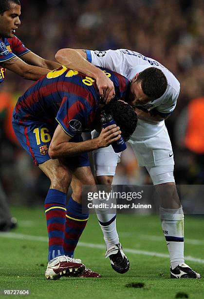 Thiago Motta of Inter Milan argues with Sergio Busquets of FC Barcelona after being sent off with a red card as Daniel Alves intervenes, during the...