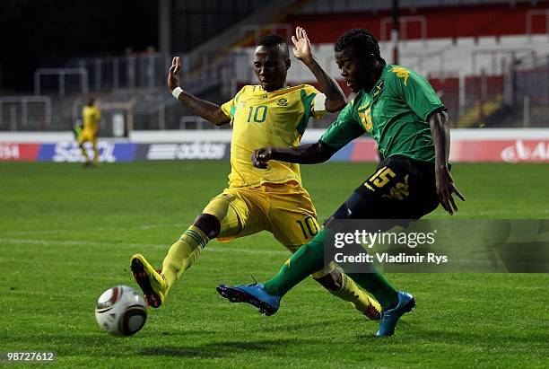 Nvian Boyd of Jamaica kicks off the ball in front of Teko Modise of South Africa during the international friendly match between South Africa and...