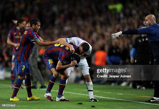Thiago Motta of Inter Milan argues with Sergio Busquets of FC Barcelona after being sent off with a red card as Daniel Alves intervenes, during the...