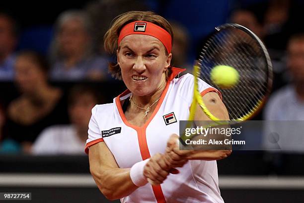 Svetlana Kuznetsova of Russia plays a backhand during her second round match against Na Li of China at day three of the WTA Porsche Tennis Grand Prix...