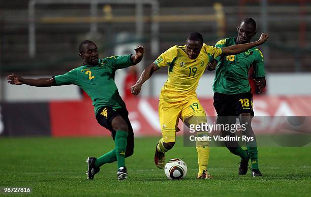 Surprise Moriri of South Africa is tackled by Richard Edwards and Xavian Virgo of Jamaica during the international friendly match between South...