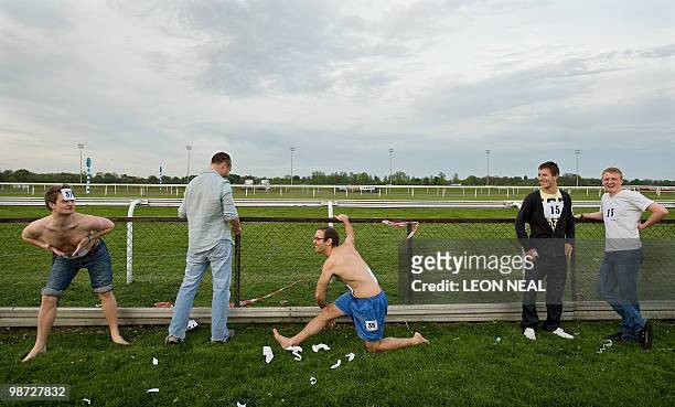 Competitors prepare for the "People's Cup" race at Kempton Park race track at Sunbury on Thames in Middlesex as riders take part in a horse race on...