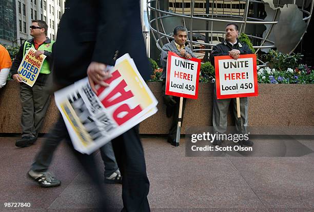 Union workers gather outside Willis Tower before a march through the financial district calling for job creation and financial reform on April 28,...