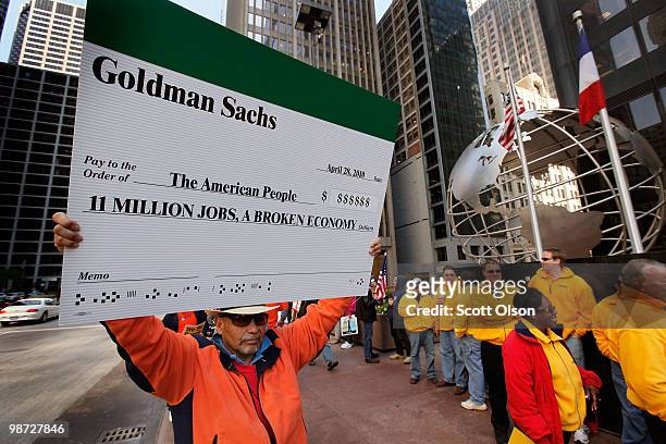 Antonio Velez holds a sign while standing among other union workers gathering outside Willis Tower before the start of a march through the financial...