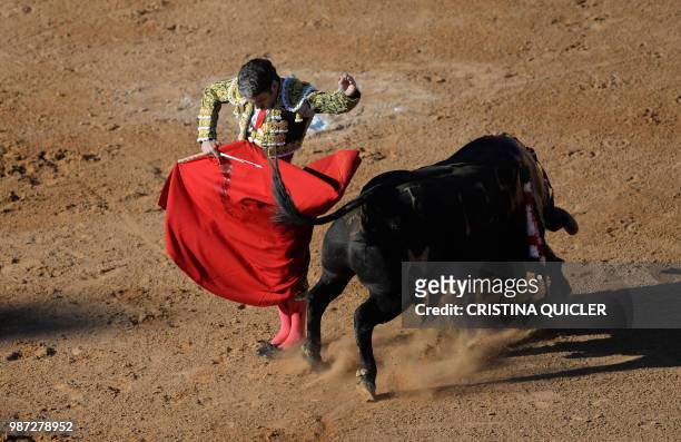 Spanish bullfighter Jose Tomas performs a pass to a bull with a muleta at the Las Palomas bullring in Aljeciras on June 29,2018