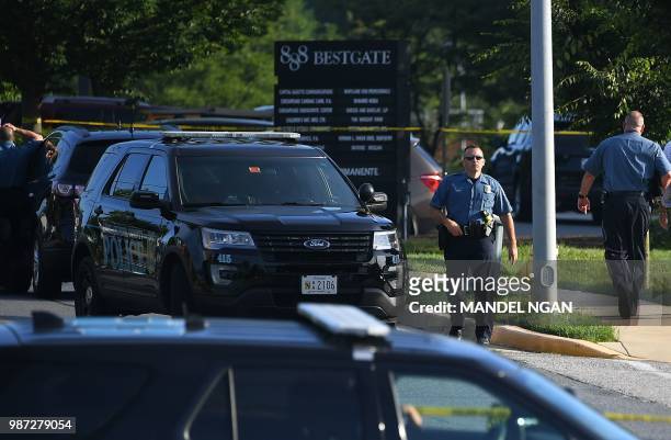 Anne Arundel County, Maryland, police are seen on a closed street leading to the Capital Gazette newspaper offices in Annapolis on June 29 one day...