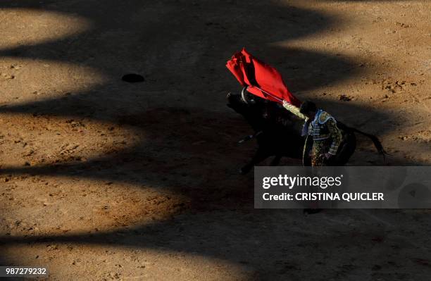 Spanish bullfighter Jose Tomas performs a pass to a bull with a muleta at the Las Palomas bullring in Aljeciras on June 29,2018