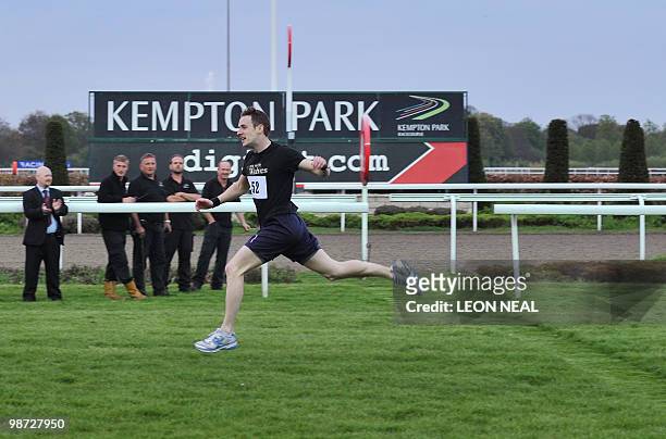 Sean Reidy crosses the finish line to take first place in the "People's Cup" race at Kempton Park race track at Sunbury on Thames in Middlesex on...