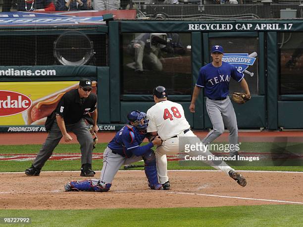 Catcher Taylor Teagarden of the Texas Rangers tags out designated hitter Travis Hafner of the Cleveland Indians on a play at the plate as homeplate...