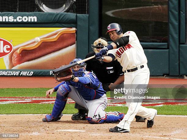 Third baseman Jhonny Peralta of the Cleveland Indians swings at a pitch as catcher Taylor Teagarden of the Texas Rangers and homeplate umpire Marvin...