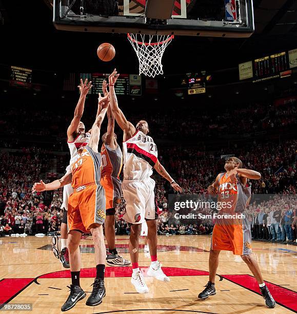 Marcus Camby of the Portland Trail Blazers rebounds against Louis Amundson, Leandro Barbosa and Grant Hill of the Phoenix Suns in Game Four of the...