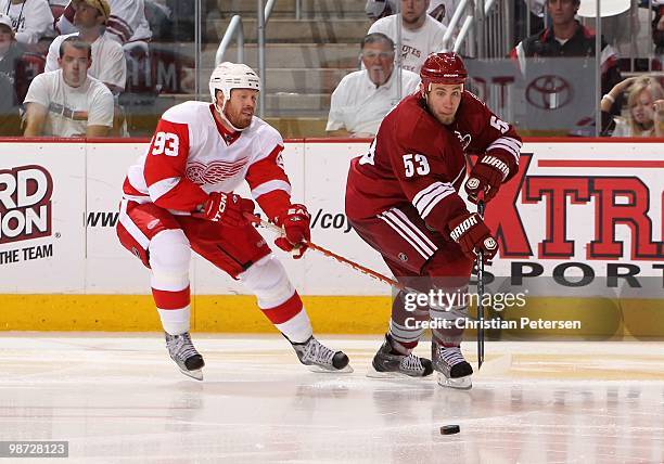 Derek Morris of the Phoenix Coyotes skates with the puck under pressure from Johan Franzen of the Detroit Red Wings in Game Seven of the Western...