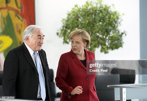 Dominique Strauss-Kahn, managing director of the International Monetary Fund and German Chancellor Angela Merkel give a statement to the press at the...