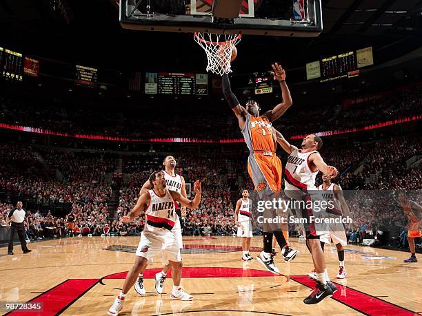 Amar'e Stoudemire of the Phoenix Suns shoots a layup against Andre Miller, Brandon Roy and Juwan Howard of the Portland Trail Blazers in Game Four of...