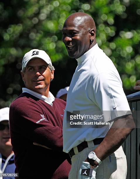 Basketball legend Michael Jordan waits with Fred Couples on a tee box during the pro am prior to the start of the 2010 Quail Hollow Championship at...
