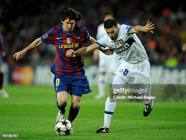 Lionel Messi of Barcelona battles Thiago Motta of Inter Milan during the UEFA Champions League Semi Final Second Leg match between Barcelona and...