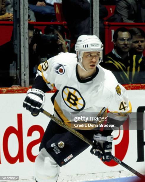 Joe Juneau of the Boston Bruins skates against the Montreal Canadiens in the early 1990's at the Montreal Forum in Montreal, Quebec, Canada.