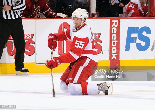 Niklas Kronwall of the Detroit Red Wings passes the puck while on his knees against the Phoenix Coyotes in Game Seven of the Western Conference...