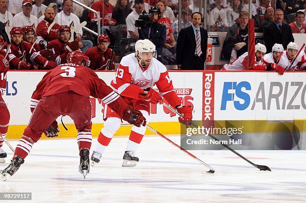 Pavel Datsyuk of the Detroit Red Wings skates the puck up ice while being defended by Keith Yandle of the Phoenix Coyotes in Game Seven of the...