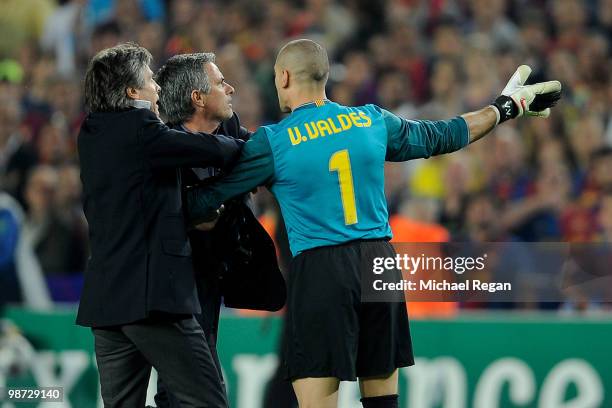 Victor Valdes of Barcelona grapples with Jose Mourinho of Inter Milan after the UEFA Champions League Semi Final Second Leg match between Barcelona...