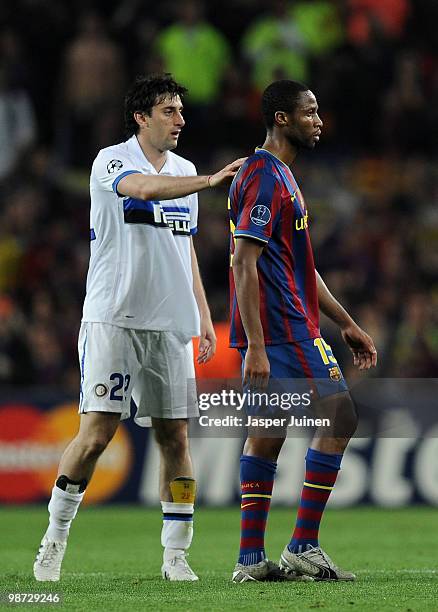 Diego Milito of Inter Milan tries to comfort Seydou Keita of FC Barcelona at the end of the UEFA Champions League semi final second leg match between...