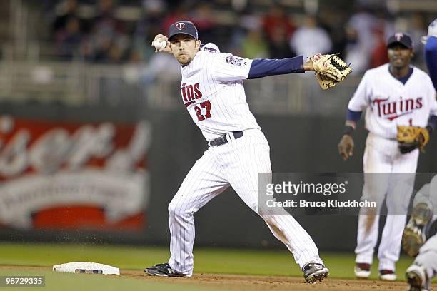 Hardy of the Minnesota Twins tries to turn a double play against the the Kansas City Royals on April 16, 2010 at Target Field in Minneapolis,...