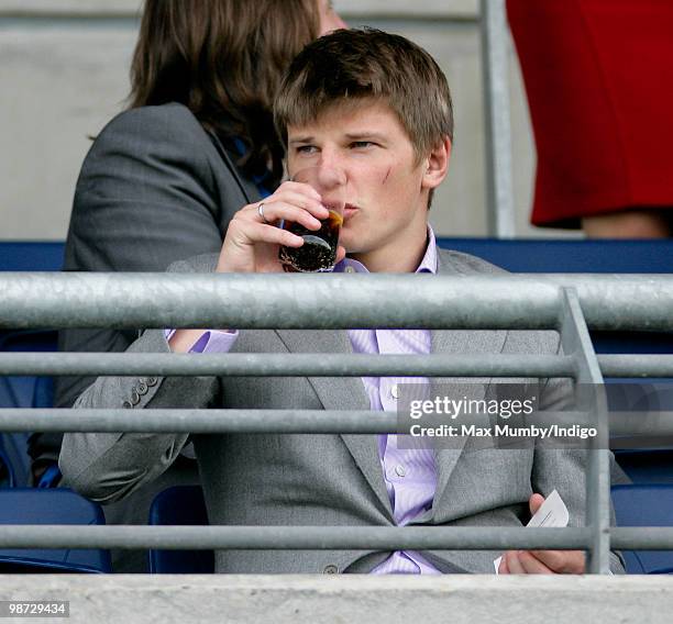 Arsenal FC player Andrey Arshavin watches the racing as he attends the Moss Bros Raceday horse racing meet on April 28, 2010 in Ascot, England.