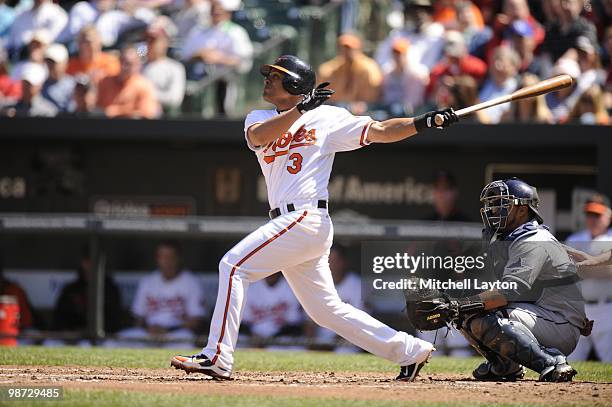 Cesar Izturis of the Baltimore Orioles takes a swing during a baseball game against the Tampa Bay Rays on April 14, 2010 at Camden Yards in...