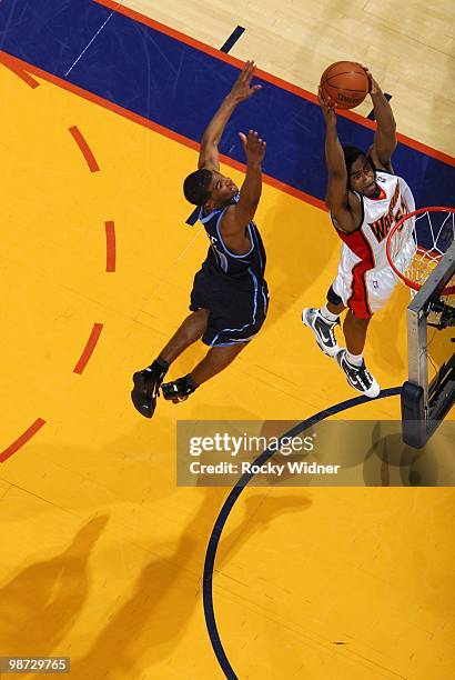 Reggie Williams of the Golden State Warriors goes to the hoop past Ronnie Price of the Utah Jazz at Oracle Arena on April 13, 2010 in Oakland,...