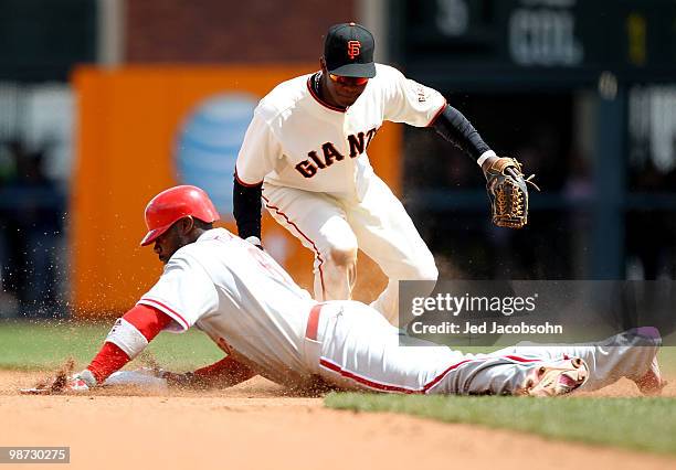 Ryan Howard of the Philadelphia Phillies slies into second after hitting a double as Edgar Renteria of the San Francisco Giants applies the tag...