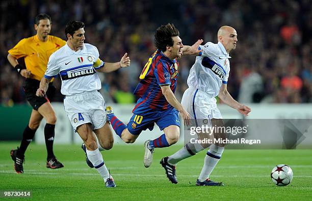 Lionel Messi of Barcelona is tackled by Javier Zanetti and Esteban Cambiasso of Inter Milan during the UEFA Champions League Semi Final Second Leg...