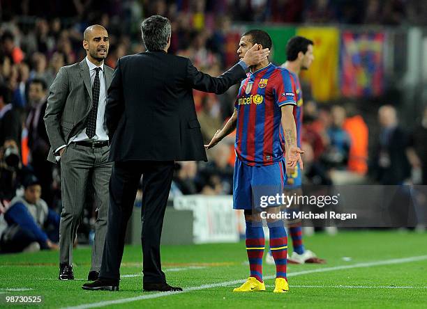Barcelona manager Josep Guardiola looks on as Inter Milan manager Jose Mourinho talks to Daniel Alves of Barcelona during the UEFA Champions League...