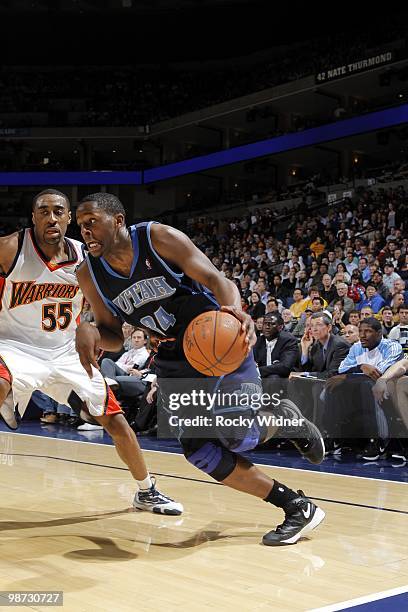 Miles of the Utah Jazz drives around Reggie Williams of the Golden State Warriors at Oracle Arena on April 13, 2010 in Oakland, California. The Jazz...