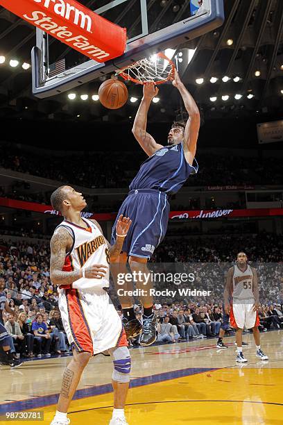 Mehmet Okur of the Utah Jazz dunks over Monta Ellis of the Golden State Warriors at Oracle Arena on April 13, 2010 in Oakland, California. The Jazz...