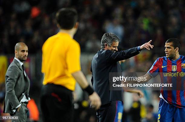 Barcelona's Brazilian defender Dani Alves and coach Josep Guardiola look at Inter Milan's Portuguese coach Jose Mourinho during the UEFA Champions...