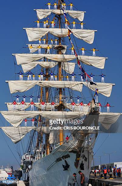 Cadets stand on the Colombian Navy sailboat Gloria rigging as they approach their mooring place at the Callao Naval Base in Peru, on April 28, 2010....