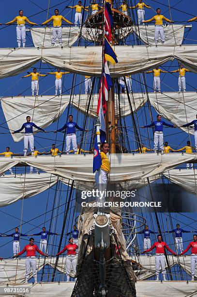 Cadets stand on the Colombian Navy sailboat Gloria rigging as they approach their mooring place at the Callao Naval Base in Peru, on April 28, 2010....