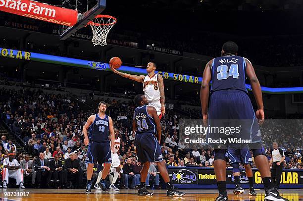 Monta Ellis of the Golden State Warriors goes to the hoop through Paul Millsap of the Utah Jazz at Oracle Arena on April 13, 2010 in Oakland,...