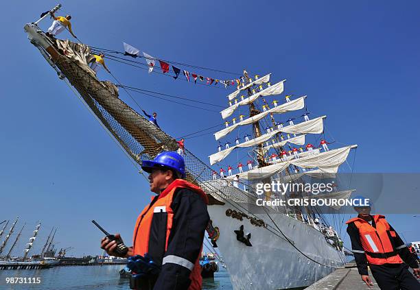 Cadets stand on the Colombian Navy sailboat Gloria rigging as they approach their mooring place at the Callao Naval Base in Peru, on April 28, 2010....