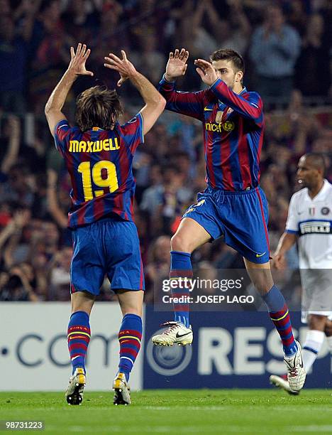 Barcelona's defender Gerard Pique is congratuled by his teammate Brazilian defender Maxwell after scoring during their UEFA Champions League...