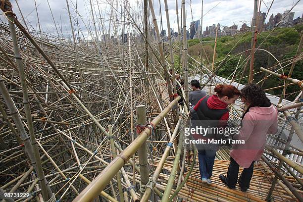 Visitors tour the Big Bambu structure created by twin brothers Mike and Doug Starn on the Metropolitan Museum of Arts' Iris and B. Gerald Cantor Roof...