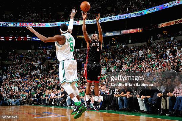 Mario Chalmers of the Miami Heat shoots over Rajon Rondo of the Boston Celtics in Game Five of the Eastern Conference Quarterfinals during the 2010...