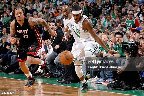 Rajon Rondo of the Boston Celtics drives the ball up court followed by Michael Beasley of the Miami Heat in Game Five of the Eastern Conference...