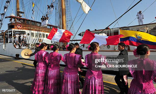 Peruvian dancers perform for the Ecuadorean cadets aboard their sailboat Guayas, after they moored at the Callao Naval Base in Peru, on April 28,...