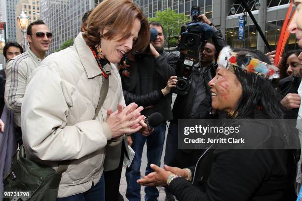Sigourney Weaver receives a gift from Manuela Omari Ima Omene at a protest of the construction of the Belo Monte Dam in Brazil in front of the...
